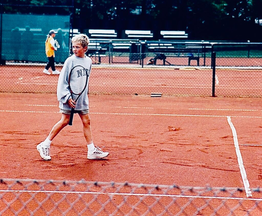 Young Jannis on a clay tennis court